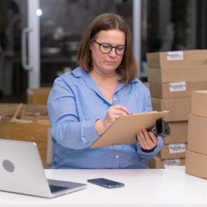 A sourcing manager reviewing product samples and shipping documents