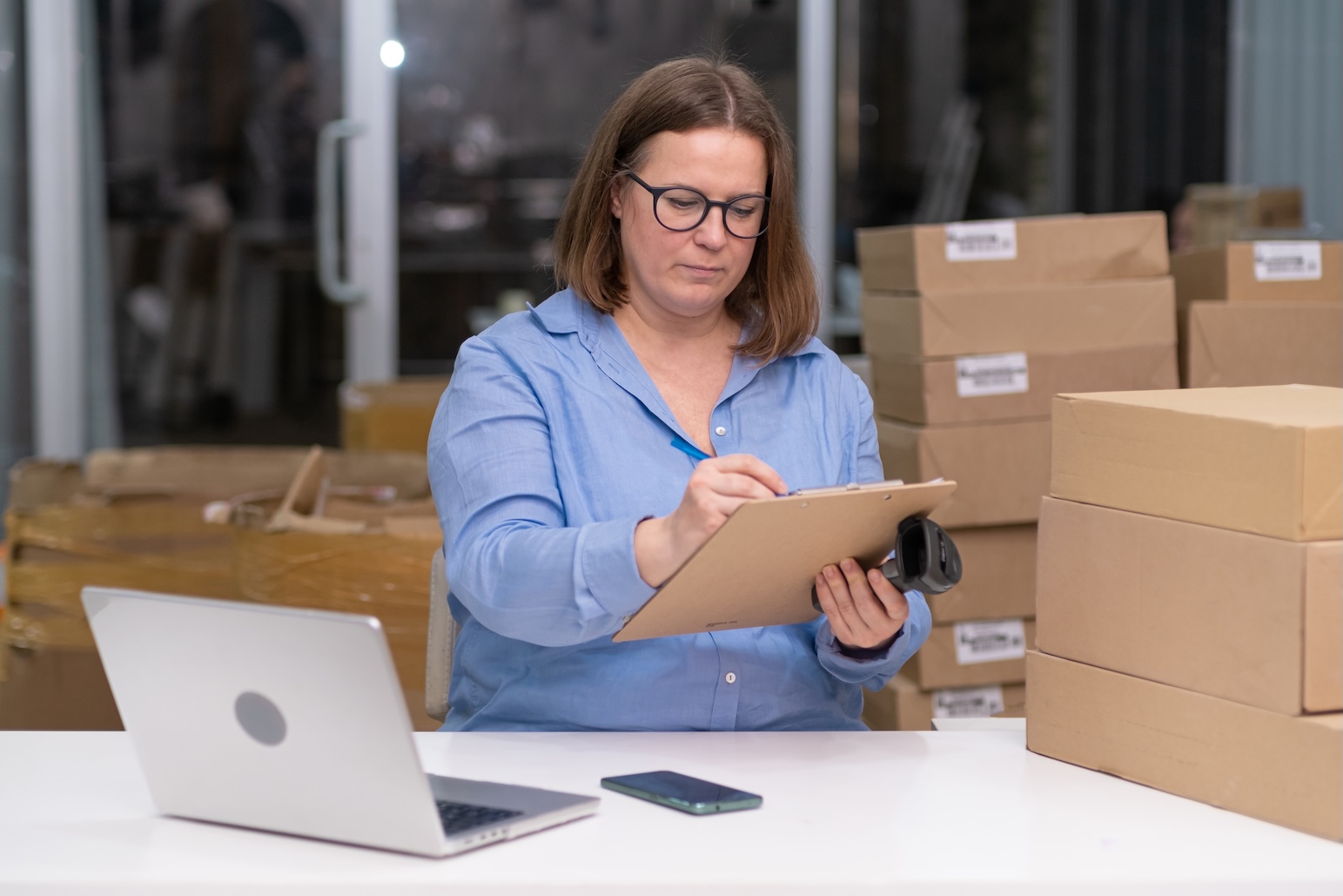A sourcing manager reviewing product samples and shipping documents